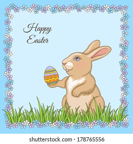 Easter rabbit in green grass holiday card with floral frame