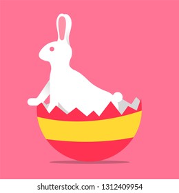 Easter rabbit standing peering out of egg in eggshell concept greeting card