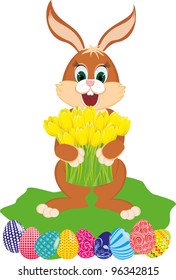 Easter rabbit with yellow tulips and the colored eggs