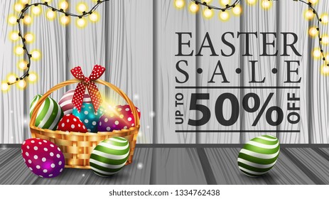 Easter sale, modern horizontal discount banner with wood texture, garland and basket with Easter eggs