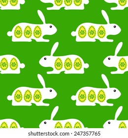Easter seamless background with rabbits decorated with eggs and flowers and lying opposite one another. For wallpaper, wrapping paper, textile decoration, invitations, greeting cards, postcards