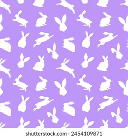 Easter seamless pattern of white rabbit silhouettes in different actions. Festive Easter bunnies design. Isolated on purple background. For Easter decoration, wrapping paper, greeting, textile, print