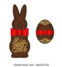 easter set of easter chocolate rabbit with text happy easter and red ribbon and chocolate egg with red ribbon