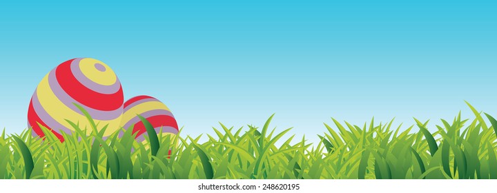 Easter Spring Scene, with grass, blue sky, copy space and two Easter Eggs