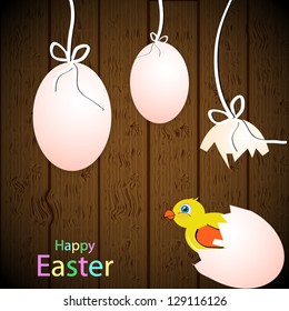 Easter theme on wooden background with eggs and chicken