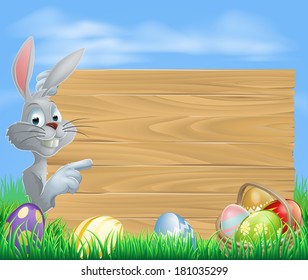 Easter white bunny rabbit pointing at a sign with a basket of chocolate Easter eggs