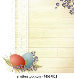 Easter wooden background with lace frame, eggs and forget-me-not flowers