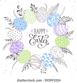 Easter wreath with hand drawn eggs and floral elements isolated on white background. Decorative frame from easter eggs with ornaments  in circle shape.