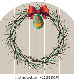 Easter wreath of willow branches with a red bow and egg on a wooden background