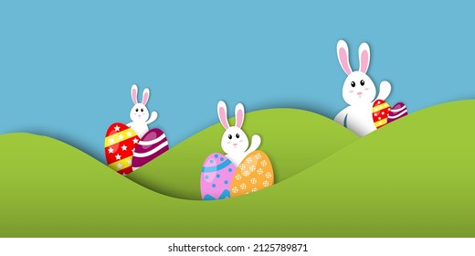 Easter's day concept. Cute rabbits or bunny, good-humored, cheerful, and colorful easter eggs with the green fields and sky