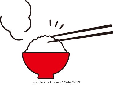 Eating cooked rice with chopsticks.