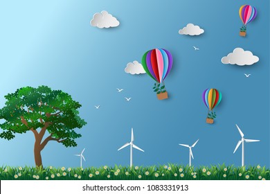 Eco friendly and environment conservation concept,colorful hot air balloon with tree flying over the meadow,paper art design
