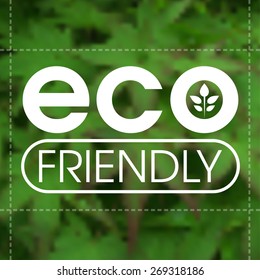 Eco friendly label against blurred green leafy background.