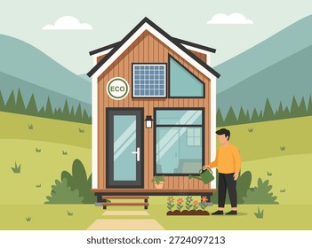 Pequeña casa respetuosa del medio ambiente con el panel solar en un paisaje pintoresco, herboso, montañoso. Un hombre riega flores en el porche delantero.