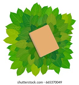 Eco-cardboard notebook framing green leaves