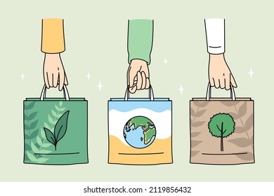 Ecology care and eco-friendly things concept. Human hands holding eco-friendly bags with pictures of plant planet and tree vector illustration 