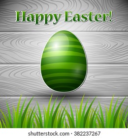 An editable vector illustration of a colored egg on a wooden background