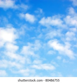 Editable vector illustration of fluffy white clouds in a blue sky made using a gradient mesh