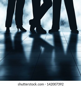 Editable vector illustration of the legs and reflections of three businesspeople made using a gradient mesh