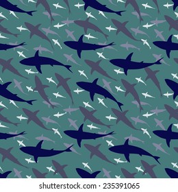 Editable vector seamless tile of a large school of sharks swimming