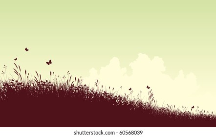 Editable vector silhouette of a grassy meadow and clouds with copy space