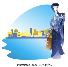 Educated young Muslim woman in a beautiful dress on a background of oriental city