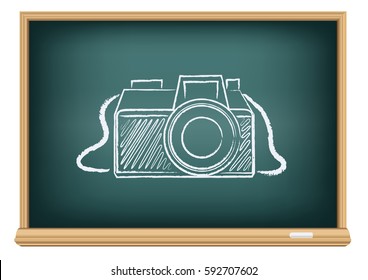 Education blackboard with drawing photographer camera. Studying photography in school.