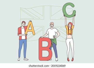 Education and English language lesson concept. Young smiling students cartoon characters standing holding english letters in hands vector illustration 