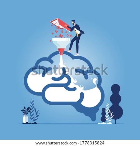Education, learning and knowledge concept-Businessman fill knowledge into machine to transform them to be knowledge and idea inside the brain. Study and learning concept
