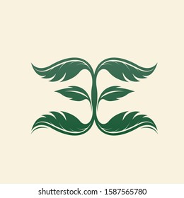 EE monogram leaf logo.Nature elements typographic icon.Alphabet initials for beauty, health care, ecological lifestyle brand.Lettering sign.Character green plant shape isolated on light background.