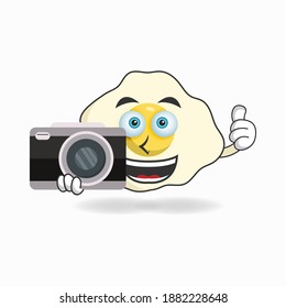 Egg mascot character holding camera. vector illustration