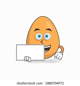 Egg mascot character holding a white blackboard. vector illustration