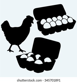 Eggs in a carton package and chicken. Isolated on blue background. Vector silhouettes