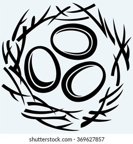 Eggs and nest. Isolated on blue background. Vector silhouettes