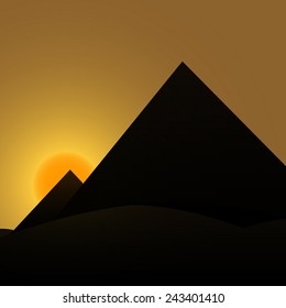 Egyptian pyramids on the background of the rising sun.