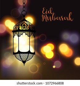 Eid Mubarak greeting on blurred background with beautiful illuminated arabic lamp and hand drawn calligraphy lettering. Vector illustration.