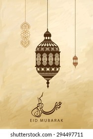 Eid mubarak - traditional arabic lantern for Eid mubarak greeting card - beautiful background with arabic calligraphy which means ''Eid mubarak ''for muslim community .