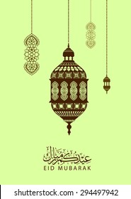 Eid mubarak - traditional arabic lantern for Eid mubarak greeting card - beautiful background with arabic calligraphy which means ''Eid mubarak ''for muslim community .