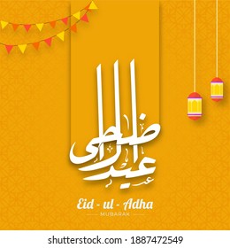 Eid-Ul-Adha Mubarak Calligraphy in Arabic Language with Hanging Lanterns and Bunting Flags on Yellow Islamic Pattern Background.