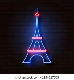 Eiffel tower in neon light on brick background