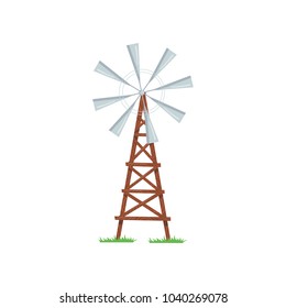 Eight-bladed wind pump used to pumping water from the ground. Old farm windmill on wooden tower. Agricultural construction. Cartoon flat vector design