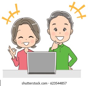 An elder couple is using a personal computer