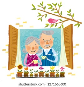 Elderly couple drinking cup of tea beside window