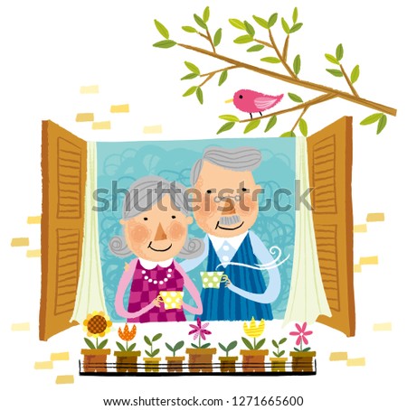 Elderly couple drinking cup of tea beside window