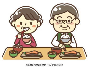 An elderly couple eating Japanese food