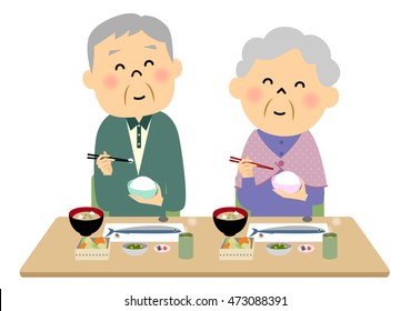 The elderly couple  eating a meal