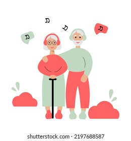 Elderly couple listening to music on their smartphone in the park. Old people using modern technology.
