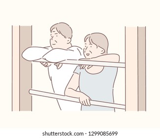 An elderly elderly couple is looking out of the window together. hand drawn style vector design illustrations.