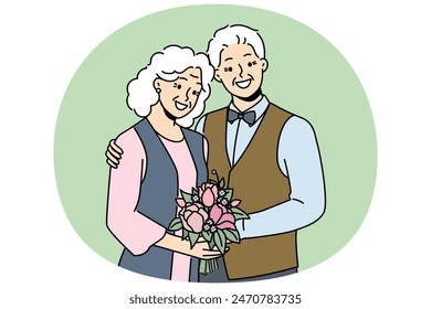 Elderly couple in love smiles rejoicing at happy family life, poses for picture on eve of golden wedding. Elderly family of man and woman hugging each other, looking at screen and laughing