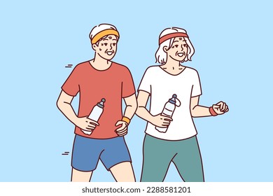 Elderly couple running and exercising outdoors having fun after retirement and enjoy active old age. Elderly men and women with water bottles do morning jog and lead healthy lifestyle